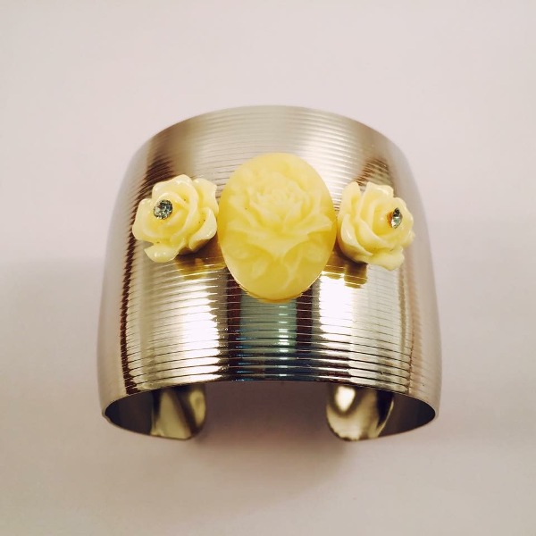 Silver toned cuff bracelet with off white flowers